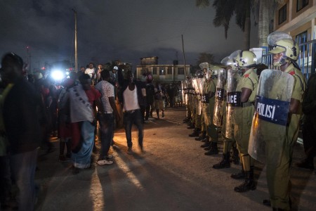 Police stand guard outside the tallying station in Kinondoni as opposition supporters celebrate throughout the night. Photo: Daniel Hayduk