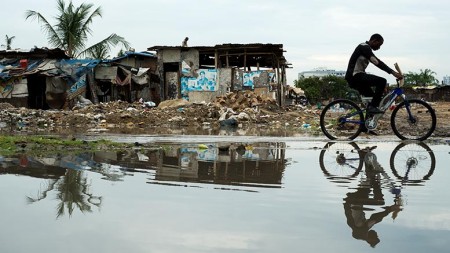 A man cycles down flooded Morogoro Rd on January 20. Photo: Daniel Hayduk